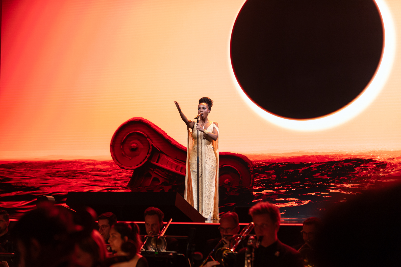 Angela Gheorghiu singing in front of the 'LIGHT' projection at ECR 2026